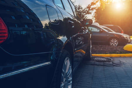 parked used black car close-up on the streetの写真素材
