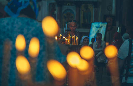 lighted candles in the church close upの写真素材