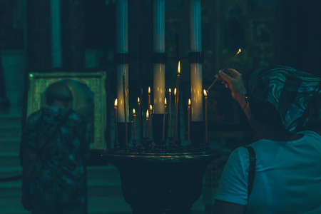 lighted candles in the church close upの写真素材