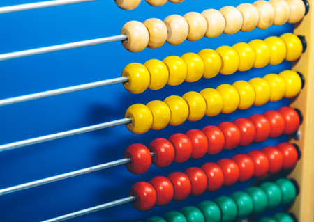 children's multi-colored abacus close up on blue backgroundの写真素材