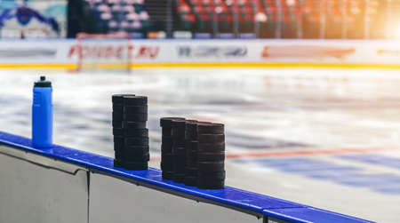 ice hockey pucks close up on iceの写真素材