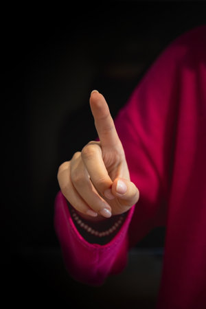 Close up of woman's hand isolated on black backgroundの写真素材
