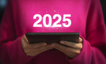 Woman holding a smartphone with the new year written on the screenの写真素材