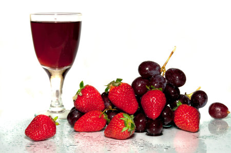 Fruit, wine in a glass, berries on the white backgroundの写真素材