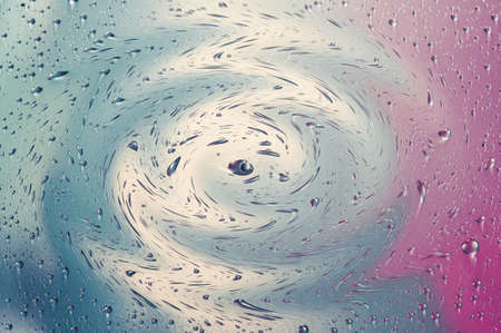 Water drops close up on a color backgroundの写真素材