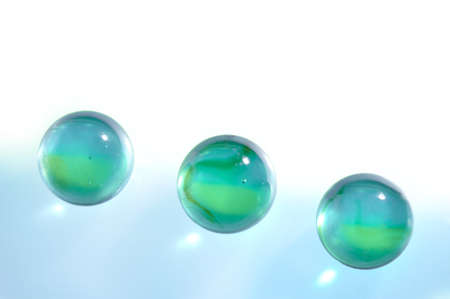 Three glass translucent spheres on an abstract backgroundの写真素材