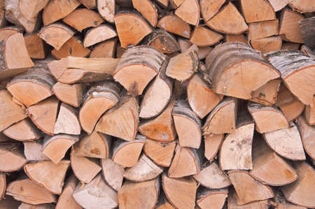 Birch chopped firewood for fireplace and stove stacked in rows close-upの写真素材