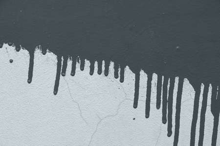 Texture of an old gray wall with cracks and paint spots close-upの写真素材