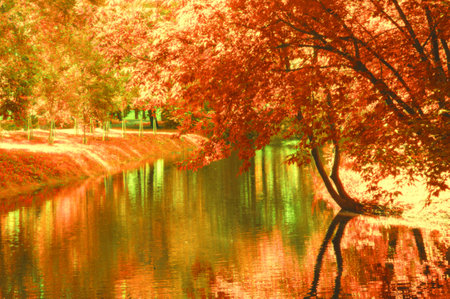 Stylized landscape of beautiful trees near the river in yellow-green colors in the city parkの写真素材