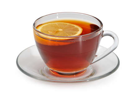 Glass cup with tea and a lemon on a glass saucer isolated on white backgroundの写真素材