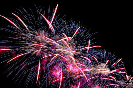 Flash of festive salute colorful fireworks against the black night sky.の写真素材