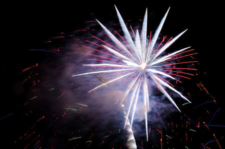 Flash of white fireworks colored sparks and white smoke.の写真素材