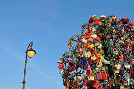 Colorful wedding padlocks on a metal tree on Luzhkov bridge in Moscow. Newlyweds traditionally hang locks for living together for a long time. Then they thrown out the key to the lock in the river.のeditorial素材