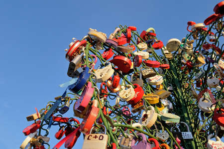 Colorful wedding padlocks on a metal tree on Luzhkov bridge in Moscow. Newlyweds traditionally hang locks for living together for a long time. Then they thrown out the key to the lock in the river.のeditorial素材