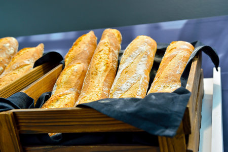 French bread baguettes in a wooden box. Photo with shallow depth of field.の写真素材