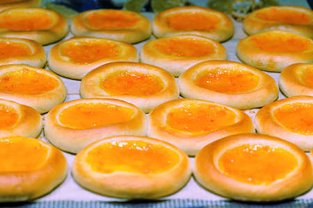 Round cake with orange jelly as a background. Photo with shallow depth of fieldの写真素材