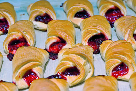 Many cakes with red jam on a light background.の写真素材