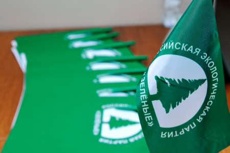 MOSCOW, RUSSIA - JULY 6, 2016: Table flags and folders with the Russian ecological "Green Party" logo.のeditorial素材