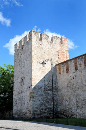 Old brick fortress wall and fortress tower against the blue skyのeditorial素材