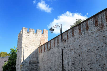 Old brick fortress wall and fortress tower against the blue skyのeditorial素材