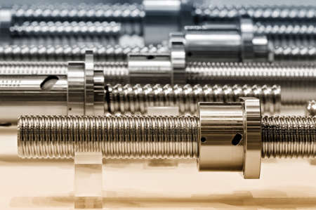 Steel rods with a screw thread and a metal round details. Selective toning, small depth of field.の写真素材