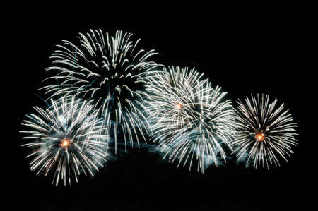 White-blue fireworks display on dark sky background.の写真素材