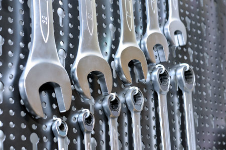 Set of manual wrenches spanners of various sizes on the metal punched panel