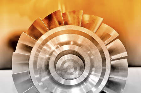 Steel industrial detail part of round shape with blades along the edge of the circle. Red toned imageの写真素材