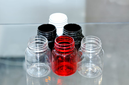 Empty plastic jars containers of different color.
