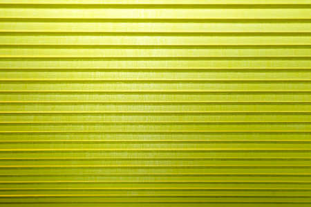 Abstract 3D background in the form of corrugated fabrics of bright yellow colorの写真素材
