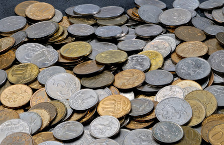 A scatter of coins 1, 5, 10 Russian kopecks. A lot of small coins with the value of one, five and...