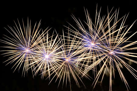 Flashes of amazing white and blue fireworks on blackの写真素材