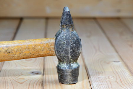 Old vintage hammer on a wooden