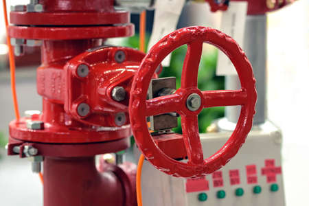 Red industrial valve on modern pipelines systemの写真素材