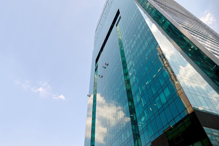 Industrial climbers washes the glass on the facade of a skyscraper.