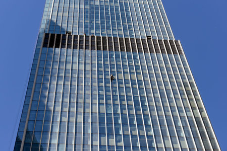 Industrial climbers washes the glass on the facade of a skyscraper.