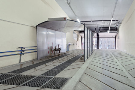 Station for automatic washing of wheels and bottoms of cars at the entrance to the underground car...