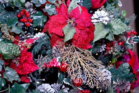 Red flowers, fir cones, green leaves as Christmas decorations. Close upの写真素材