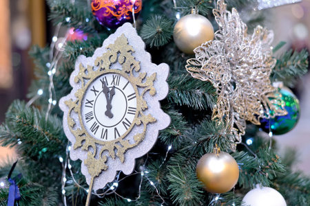 White cardboard decorative clock and ball toy hang like Christmas toys on a New Year and Christmas...