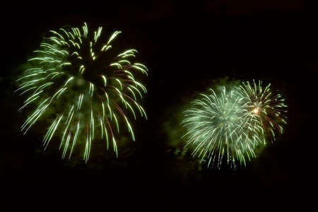 Amazing green fireworks on dark background. Flashes of fireworks of green colorの写真素材