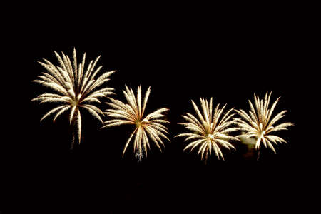 Amazing golden fireworks on dark background.  Beautiful gold color fireworks displayの写真素材