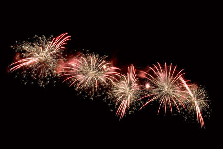 Celebratory fireworks in the form of flashes of unusual shapes in different colors against a twilight skyの写真素材
