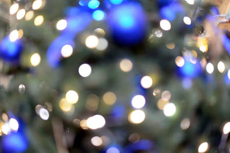 Blurry New Year and Christmas lights and Christmas toys. New Year and Christmas festive bokeh. Abstract background of garlands and Christmas toys.の写真素材