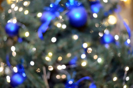 Abstract background lights and christmas toys. New Year and Christmas bokeh from burning lights and Christmas tree decorations.の写真素材