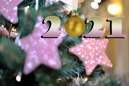 New Year card with blurry Christmas tree decorations background and date 2021