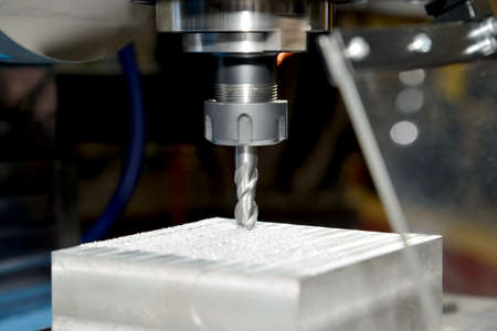 Metal billet is machined on an industrial milling machineの写真素材