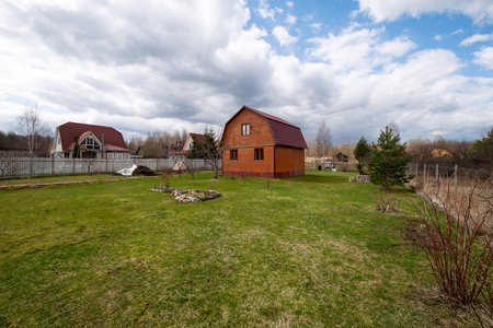 Typical Russian cottage, dacha in Russian. Dacha is a house for seasonal residence, located in the countryside. Designed for family recreation and the cultivation of fruits and vegetablesの写真素材