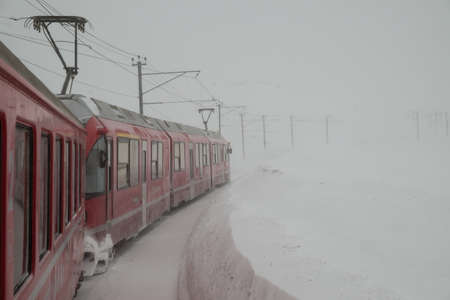DIAVOLEZZA, SWITZERLAND - January, 2018. The train Bernina Express,  crosses the Swiss alps in winter with snowのeditorial素材