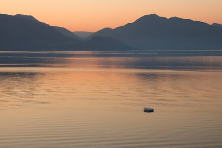 Lonely boat in the sea on sunrise  in a calm  Pastel tones  Marmaris  Turkey の写真素材