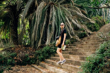 Young woman walking on stones stairs in forestの写真素材